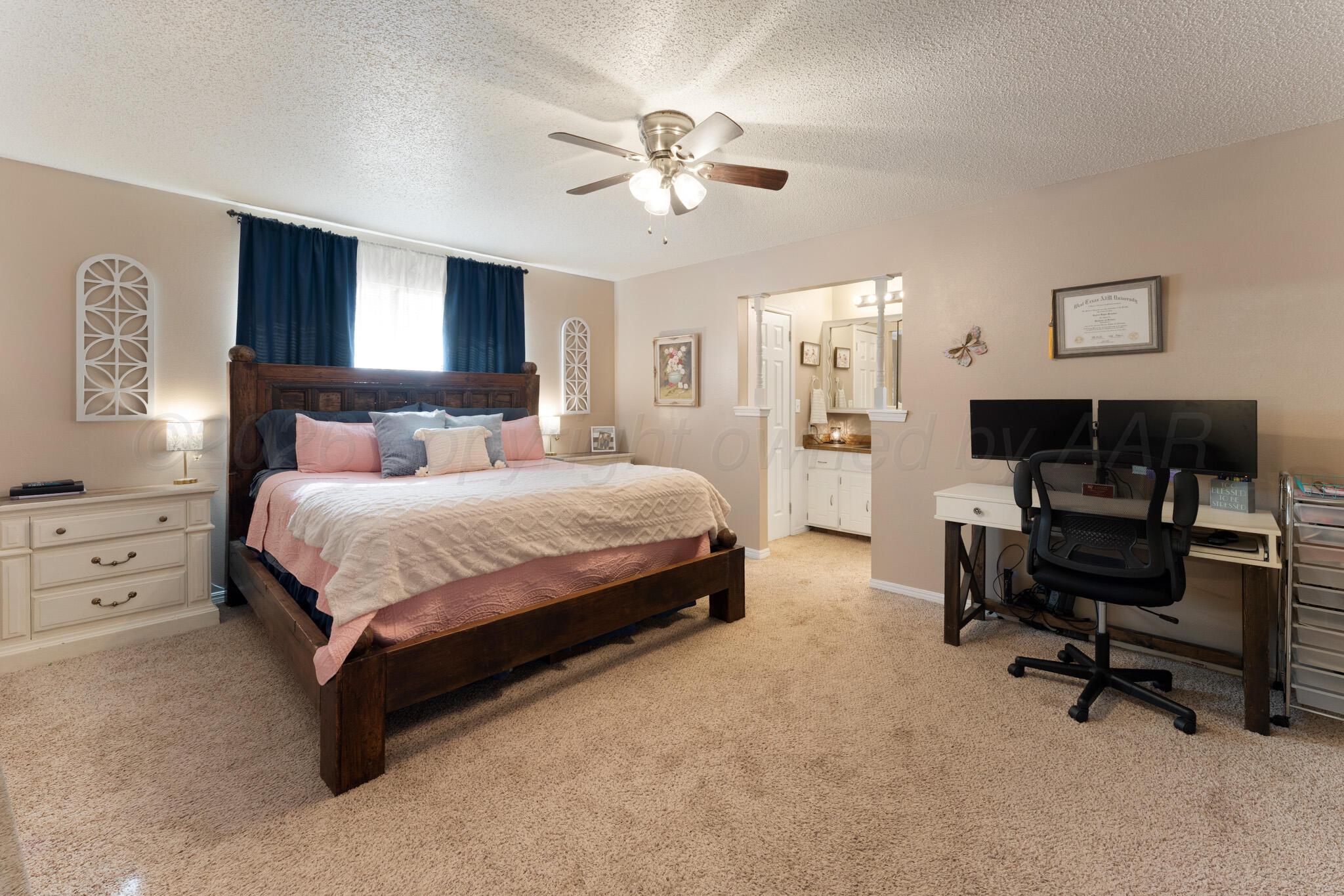 6114 Cornell Street Amarillo, TX 79109 - Photo 16 of 33 a bedroom with a bed a computer on a desk and chair