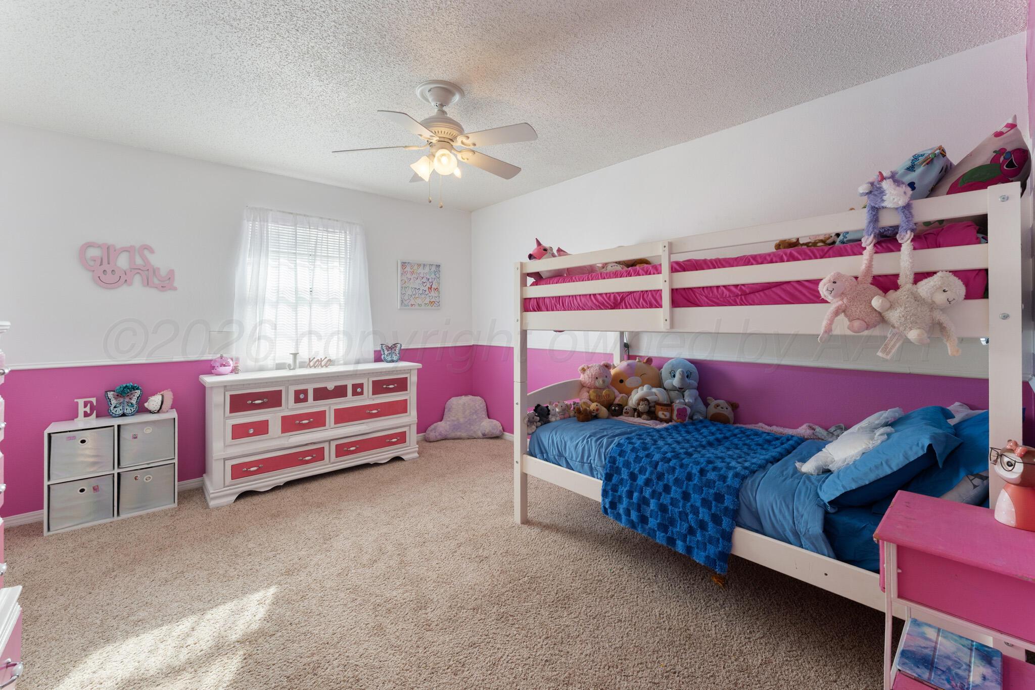 6114 Cornell Street Amarillo, TX 79109 - Photo 22 of 33 a bedroom with bed and a chandelier