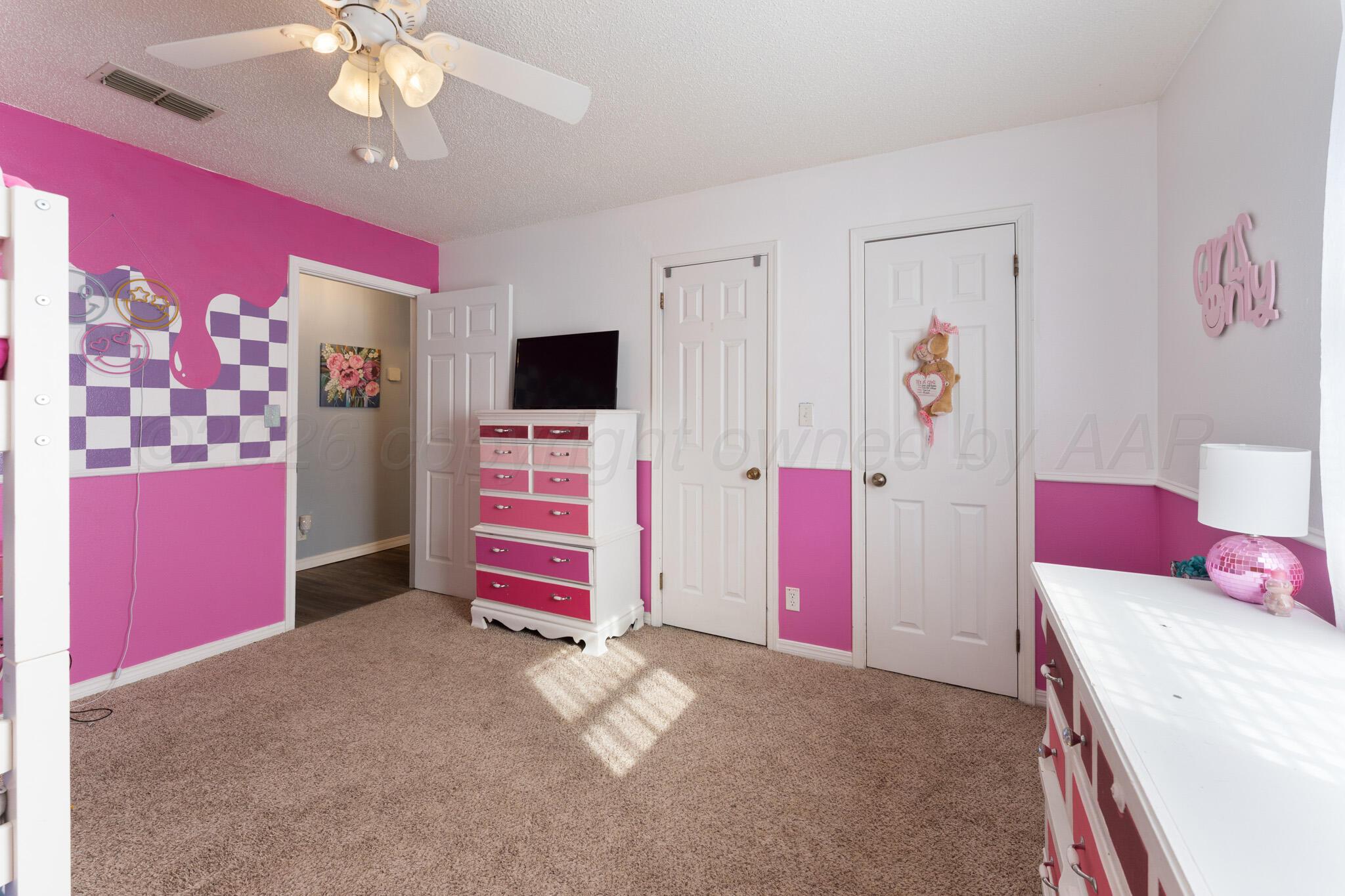 6114 Cornell Street Amarillo, TX 79109 - Photo 23 of 33 a bedroom with furniture and chandelier