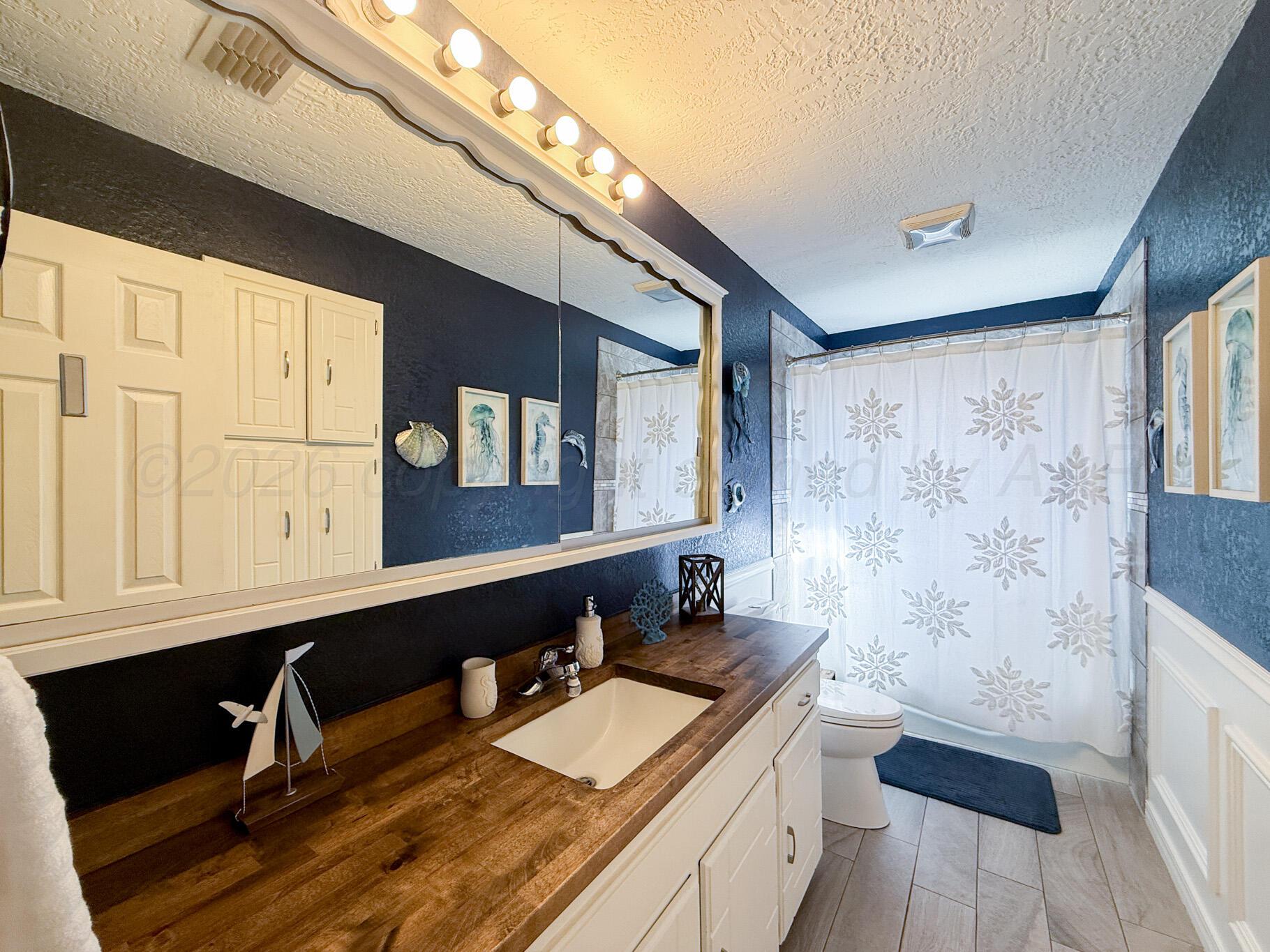 6114 Cornell Street Amarillo, TX 79109 - Photo 24 of 33 a bathroom with a sink a double vanity and a mirror