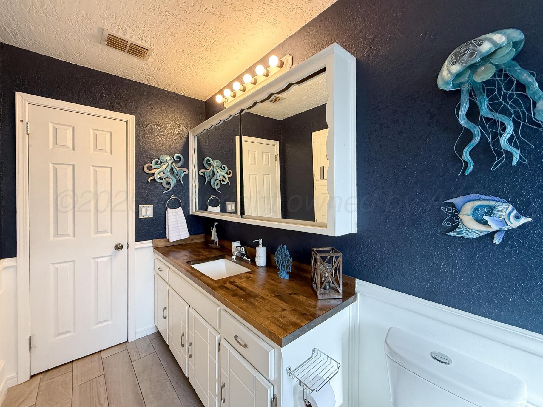 6114 Cornell Street Amarillo, TX 79109 - Photo 25 of 33 a bathroom with a sink and a mirror