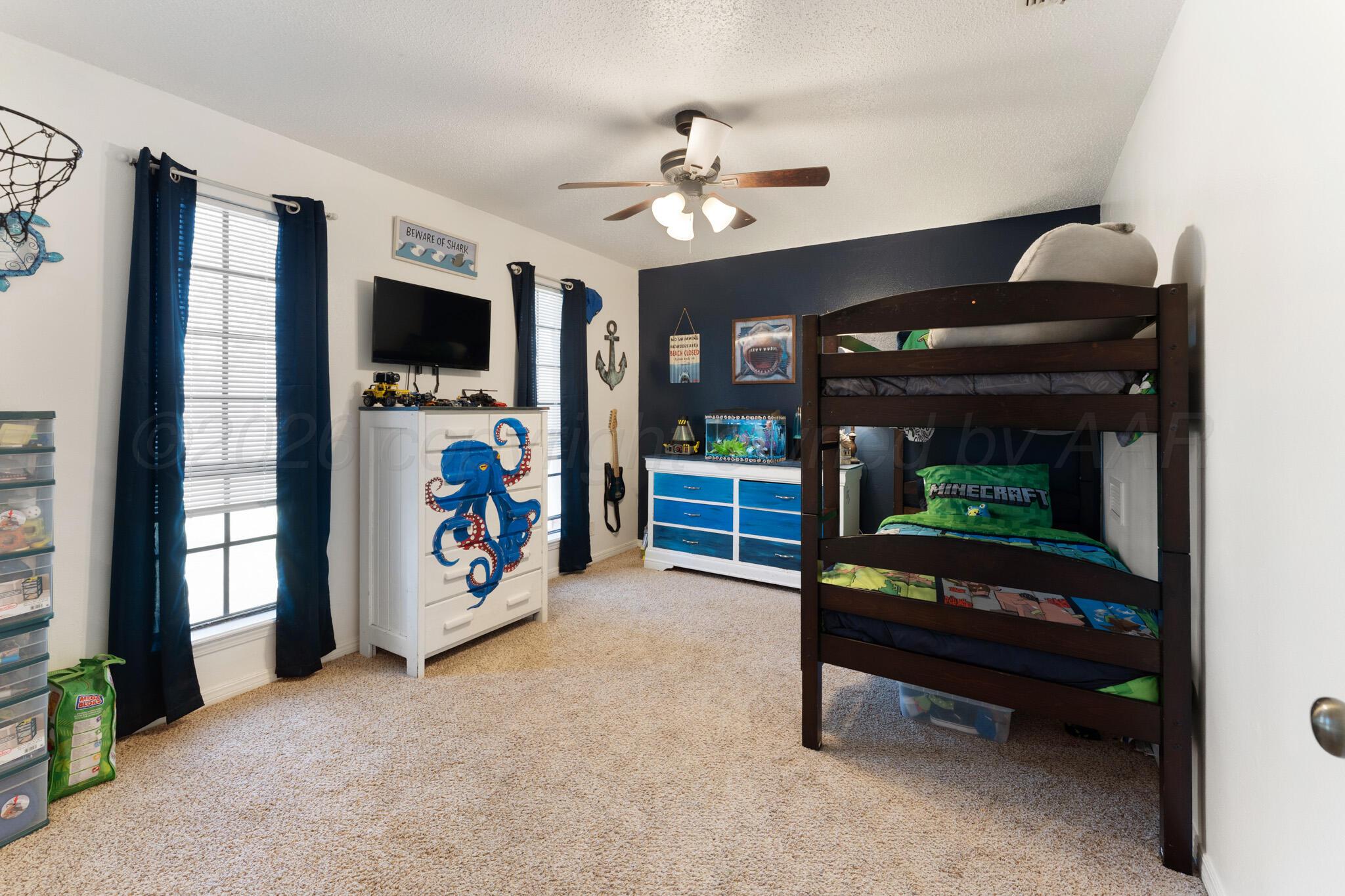 6114 Cornell Street Amarillo, TX 79109 - Photo 26 of 33 a living room with furniture and a flat screen tv