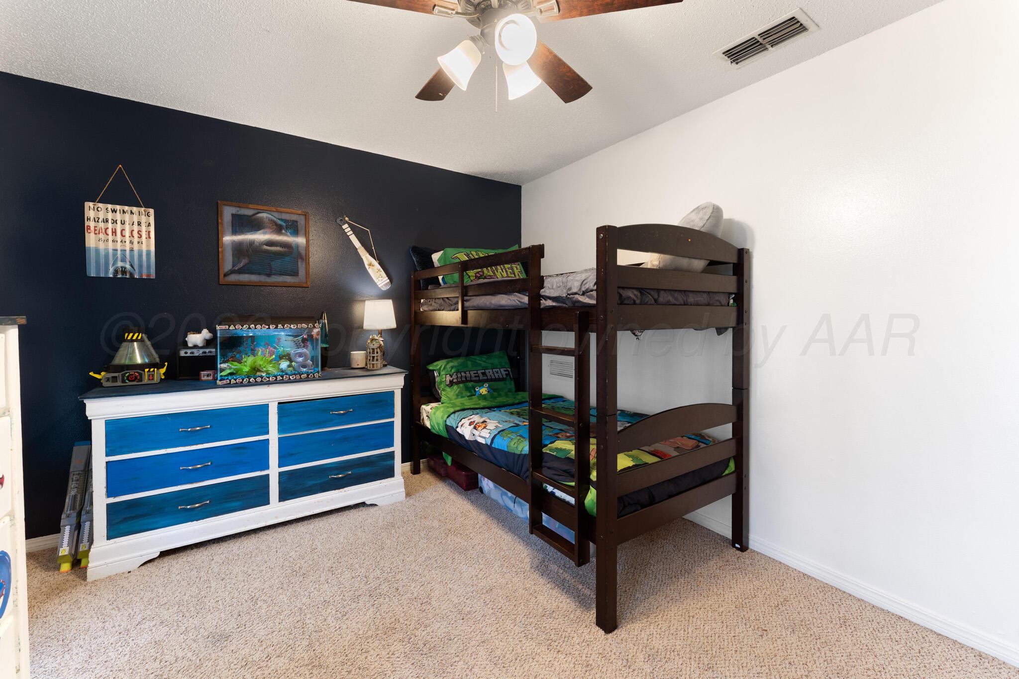 6114 Cornell Street Amarillo, TX 79109 - Photo 27 of 33 a bedroom with furniture and a baby crib