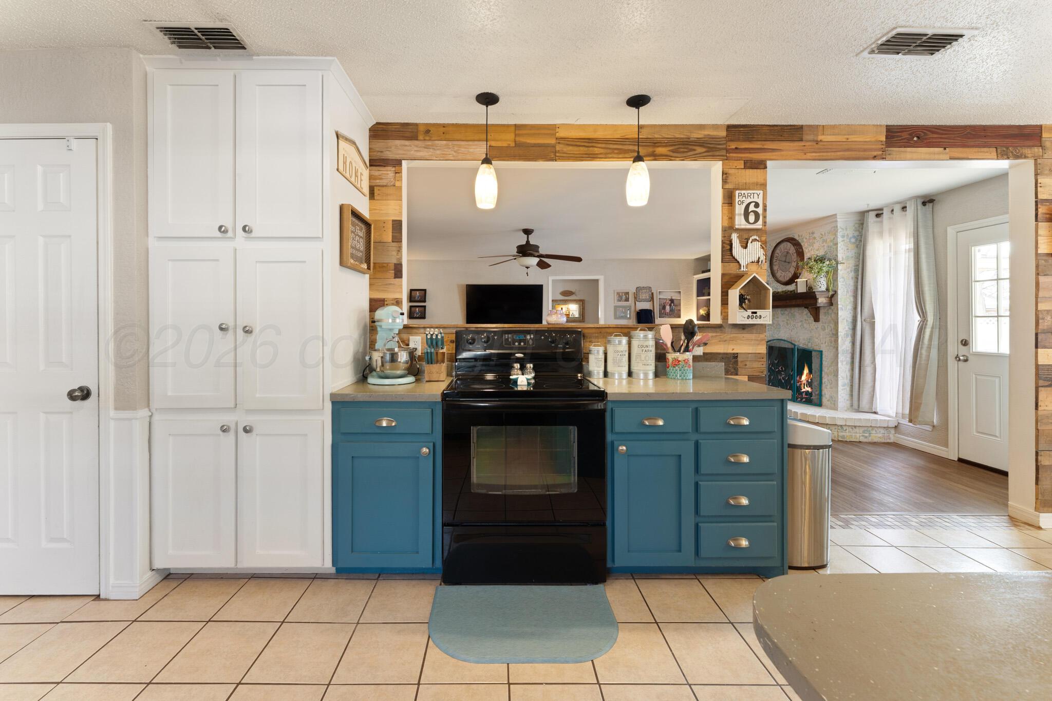 6114 Cornell Street Amarillo, TX 79109 - Photo 9 of 33 a kitchen with stainless steel appliances granite countertop a stove and a refrigerator