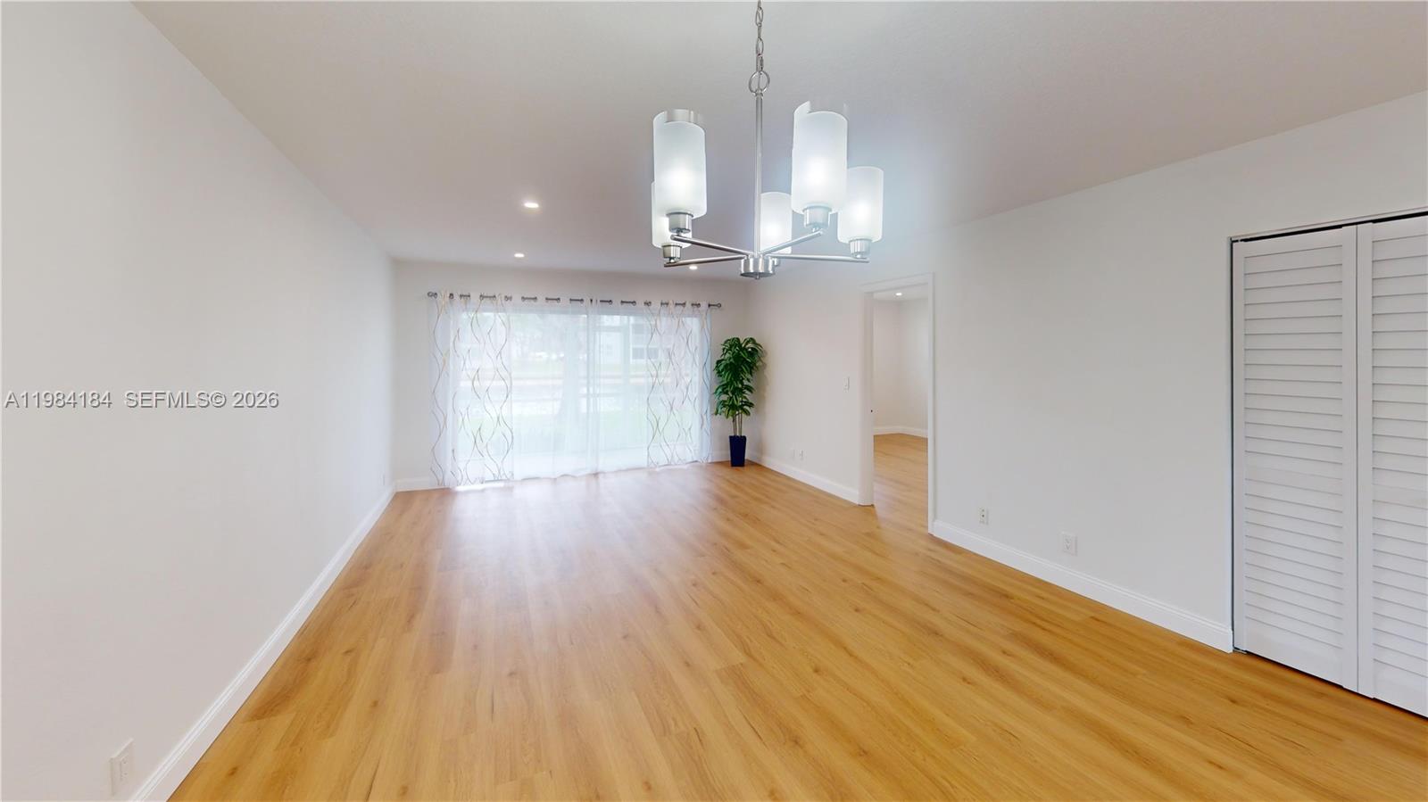 8846 West McNab Road, Unit 106 Tamarac, FL 33321 - Photo 11 of 39 a view of a room with wooden floor and kitchen