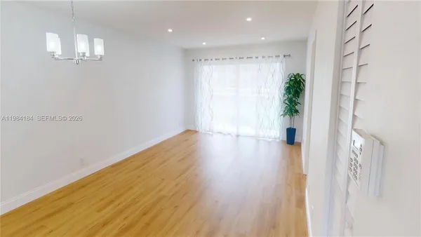 a kitchen with a sink and wooden floor