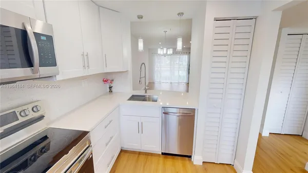 a view of kitchen and kitchen with stainless steel appliances