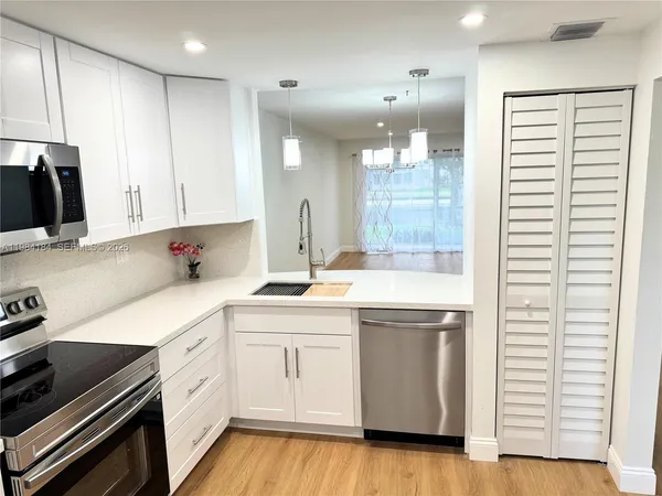 a view of room with window and wooden floor