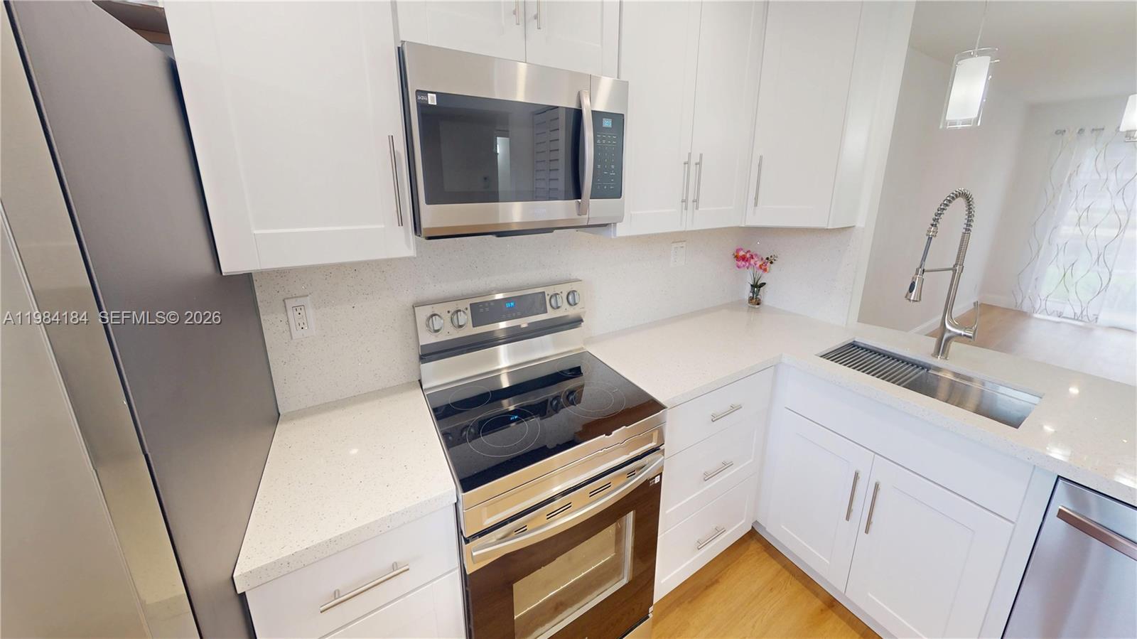 8846 West McNab Road, Unit 106 Tamarac, FL 33321 - Photo 19 of 39 a kitchen with sink and cabinets