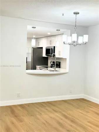 a bathroom with a sink mirror vanity and toilet