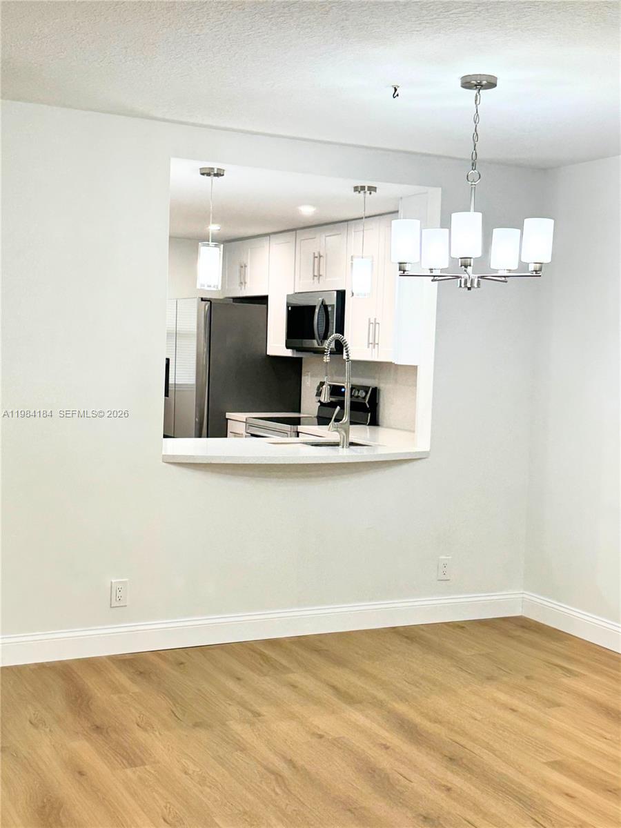 8846 West McNab Road, Unit 106 Tamarac, FL 33321 - Photo 23 of 39 a view of kitchen and kitchen with stainless steel appliances