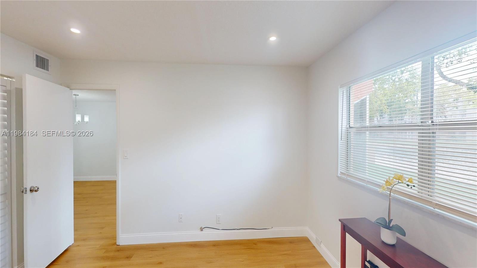 8846 West McNab Road, Unit 106 Tamarac, FL 33321 - Photo 24 of 39 a view of room with window and wooden floor