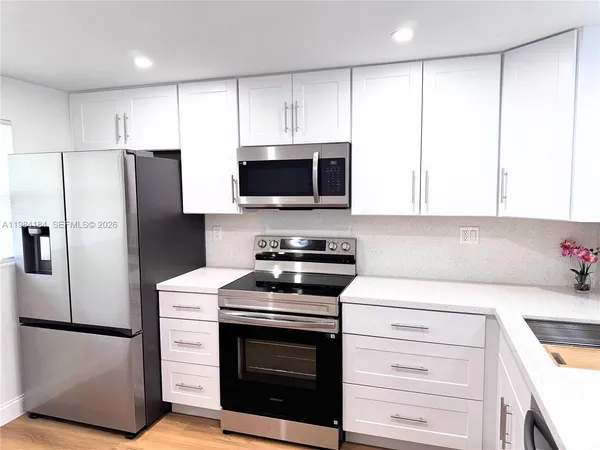 a kitchen with a refrigerator stove and microwave