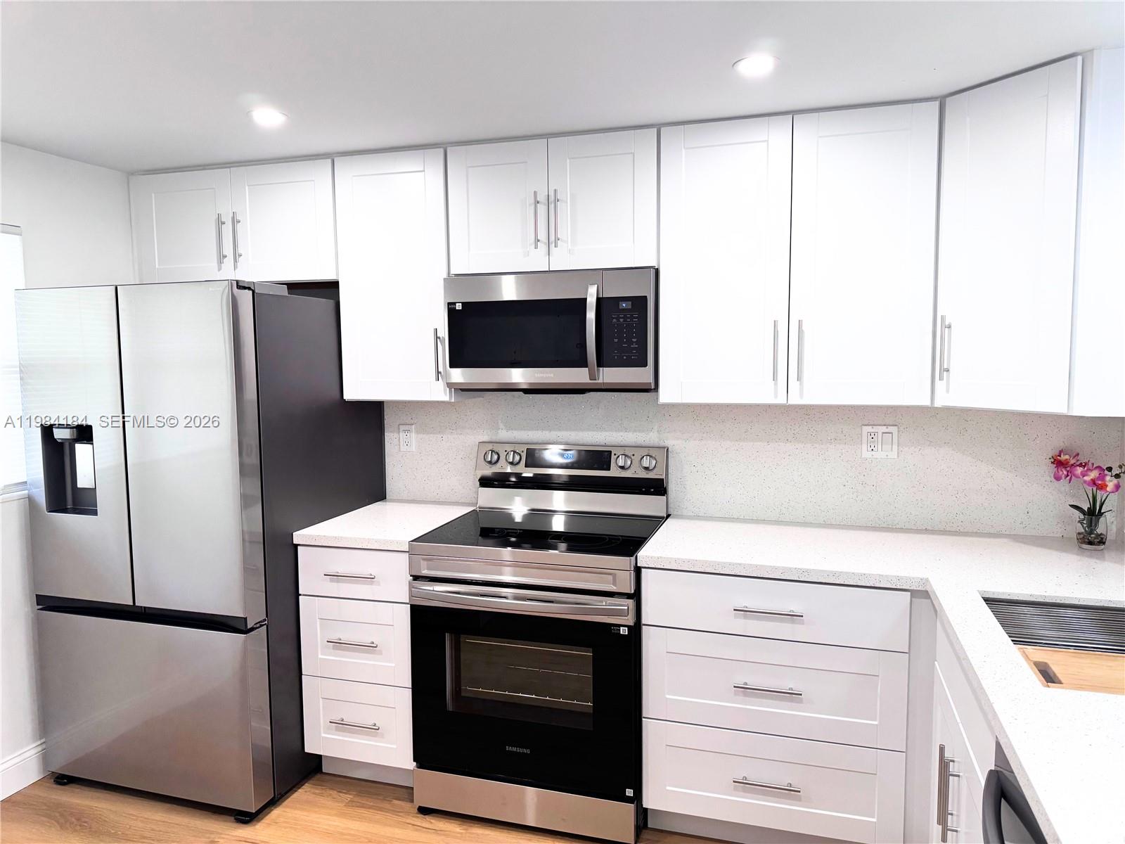 8846 West McNab Road, Unit 106 Tamarac, FL 33321 - Photo 3 of 39 a kitchen with a refrigerator stove and microwave