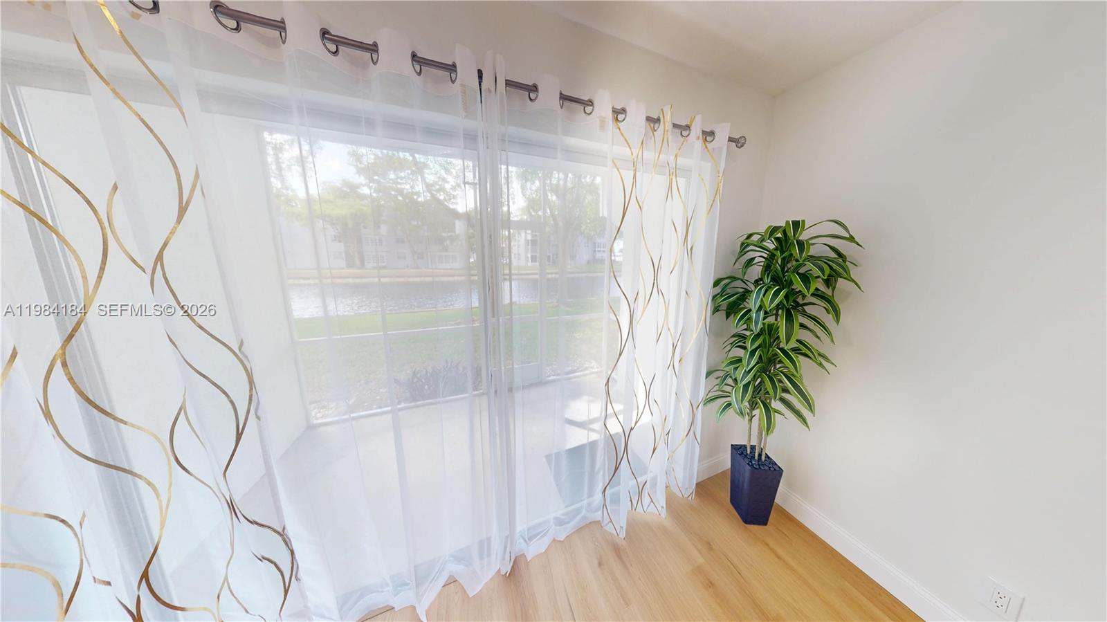 8846 West McNab Road, Unit 106 Tamarac, FL 33321 - Photo 8 of 39 a close up of a flower pot with a window