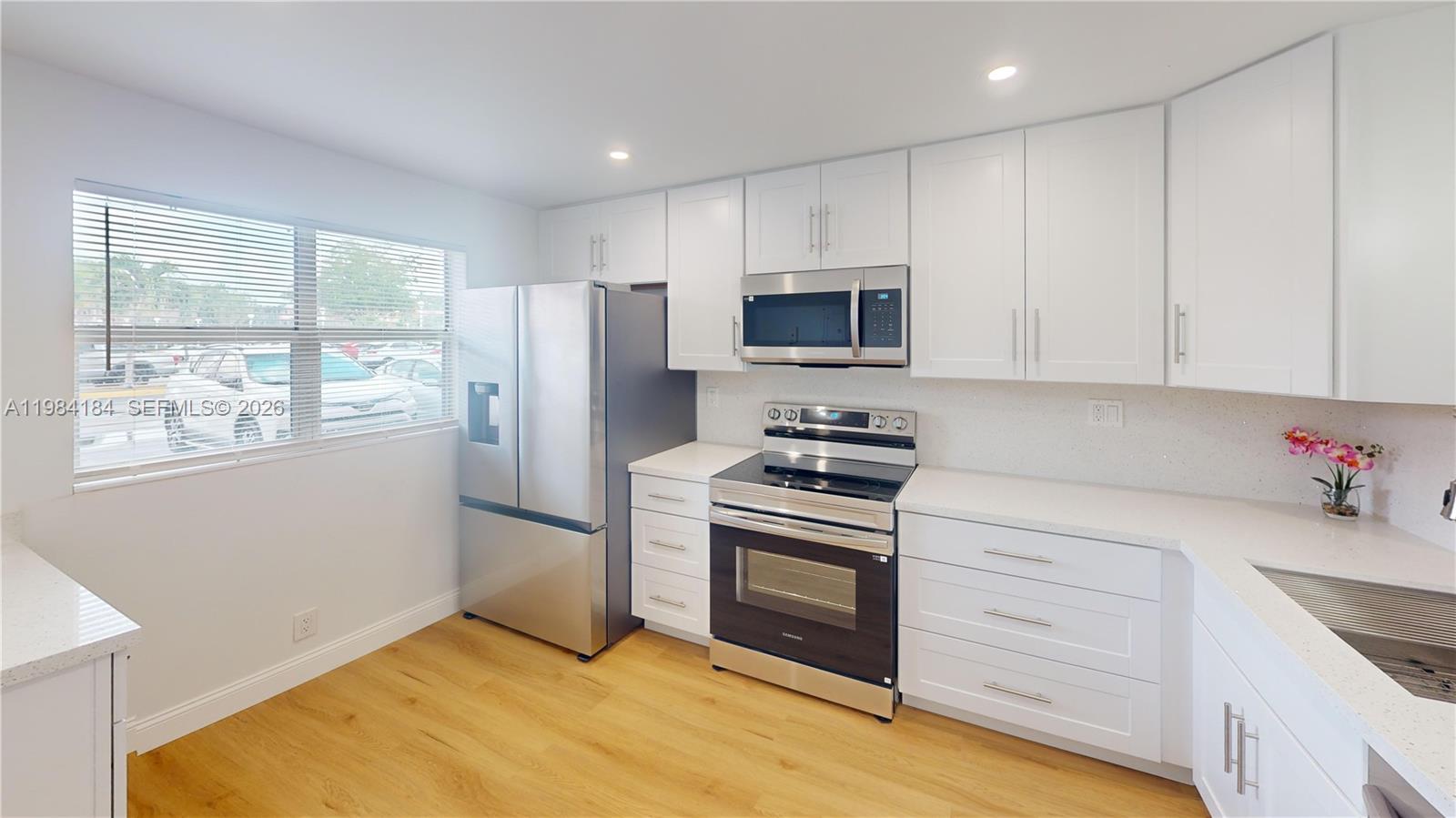 8846 West McNab Road, Unit 106 Tamarac, FL 33321 - Photo 9 of 39 a kitchen with stainless steel appliances a stove microwave and refrigerator
