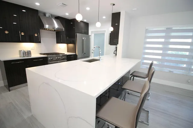 a kitchen with a sink and a stove top oven