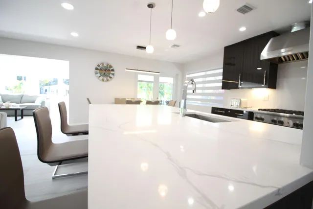 a view of a patio with table and chairs potted plants