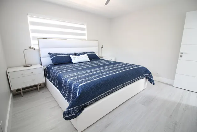 a bedroom with furniture and a potted plant