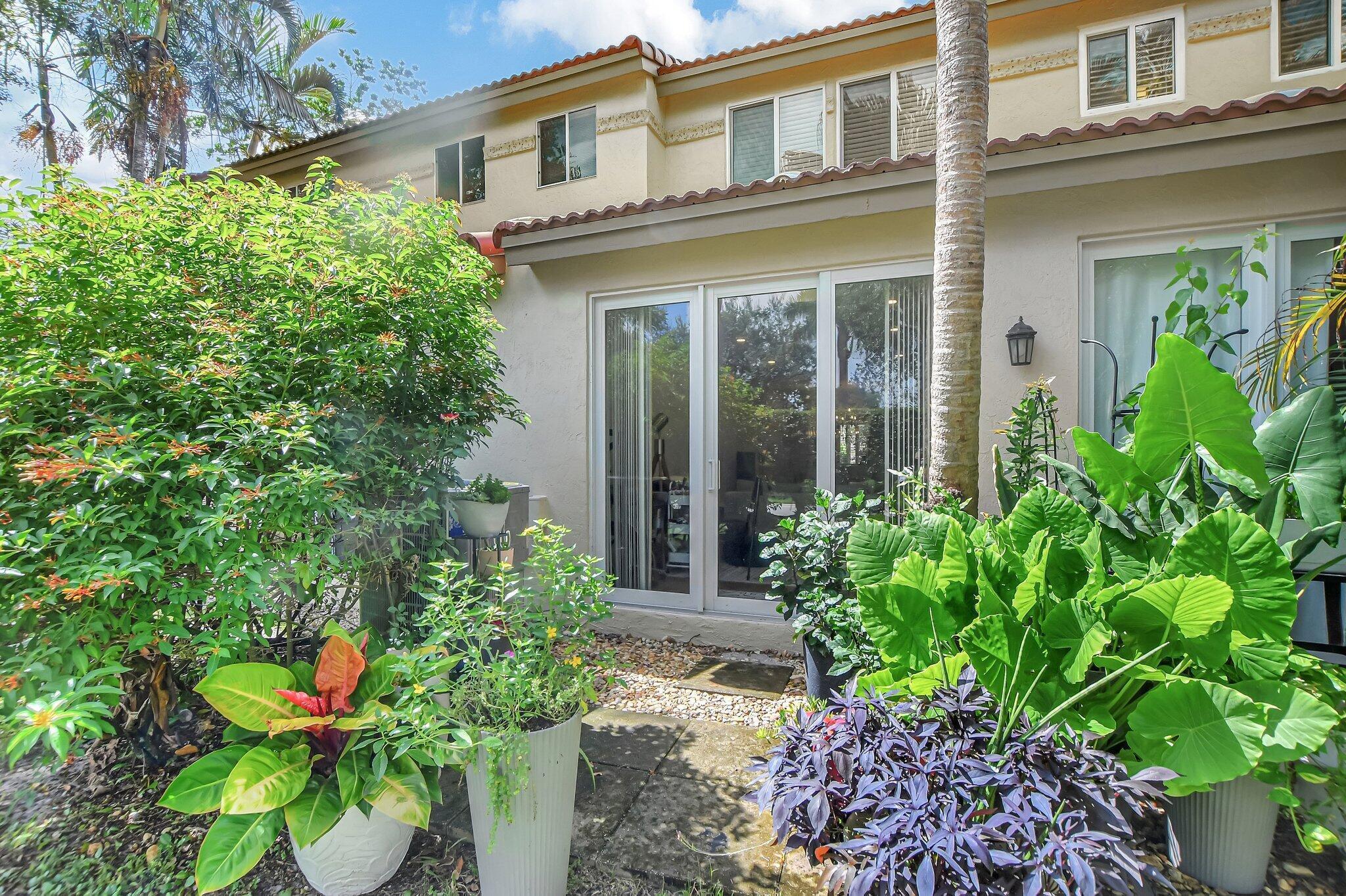 6682 Via Regina Boca Raton, FL 33433 - Photo 32 of 46 a front view of a house with a plant