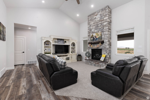 186 West 580 North Redmond, UT 84652 - Photo 9 of 74 Living room with vaulted ceiling, a ceiling fan, dark wood-style floors, and a fireplace