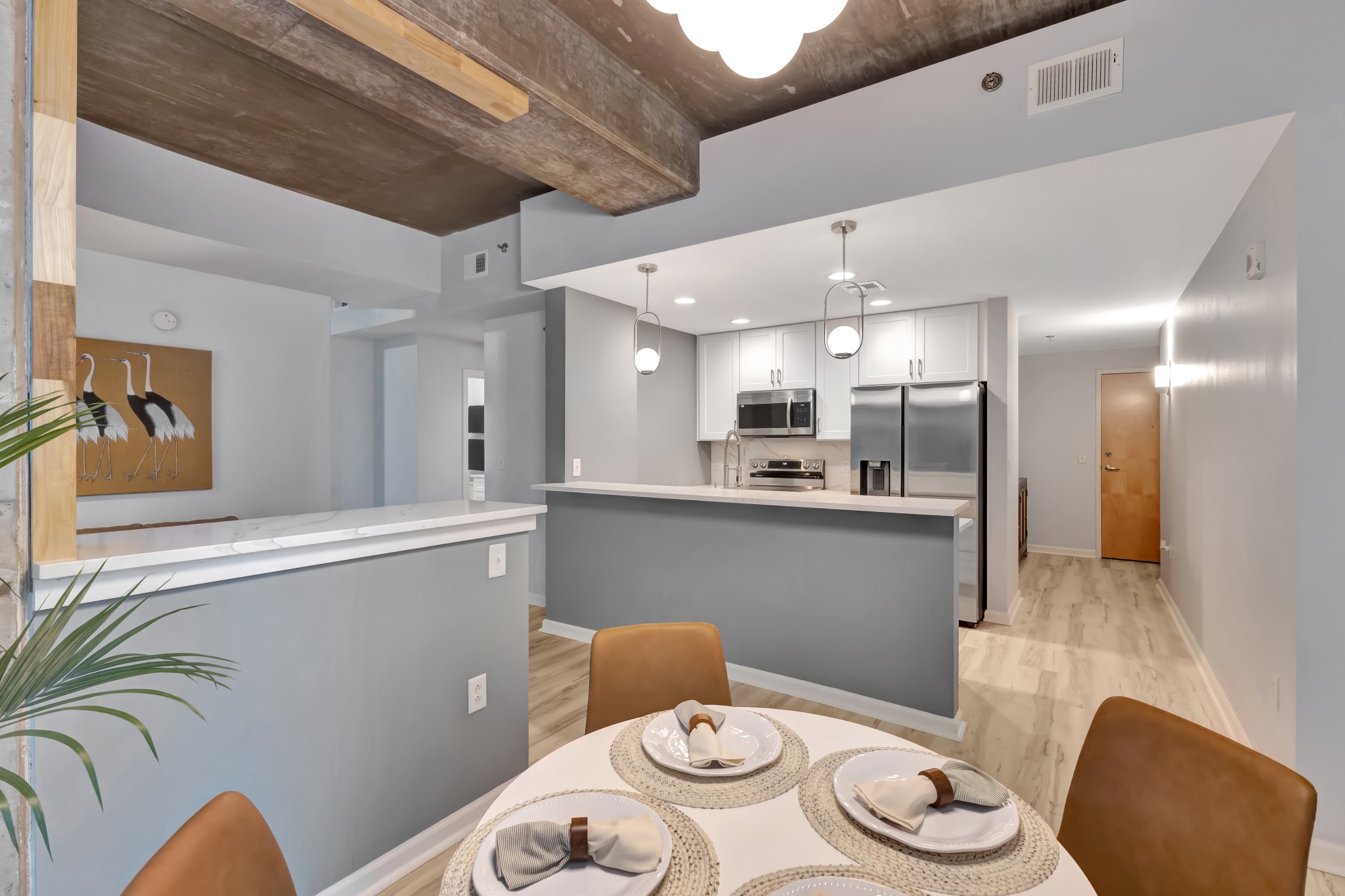 415 Church Street, Unit 1805 Nashville, TN 37219 - Photo 12 of 66 a kitchen with stainless steel appliances a dining table and chairs