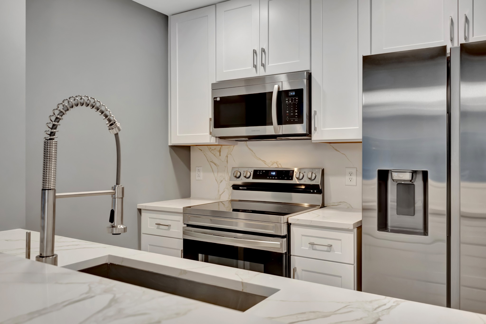 415 Church Street, Unit 1805 Nashville, TN 37219 - Photo 16 of 66 a kitchen with stainless steel appliances a stove microwave and cabinets