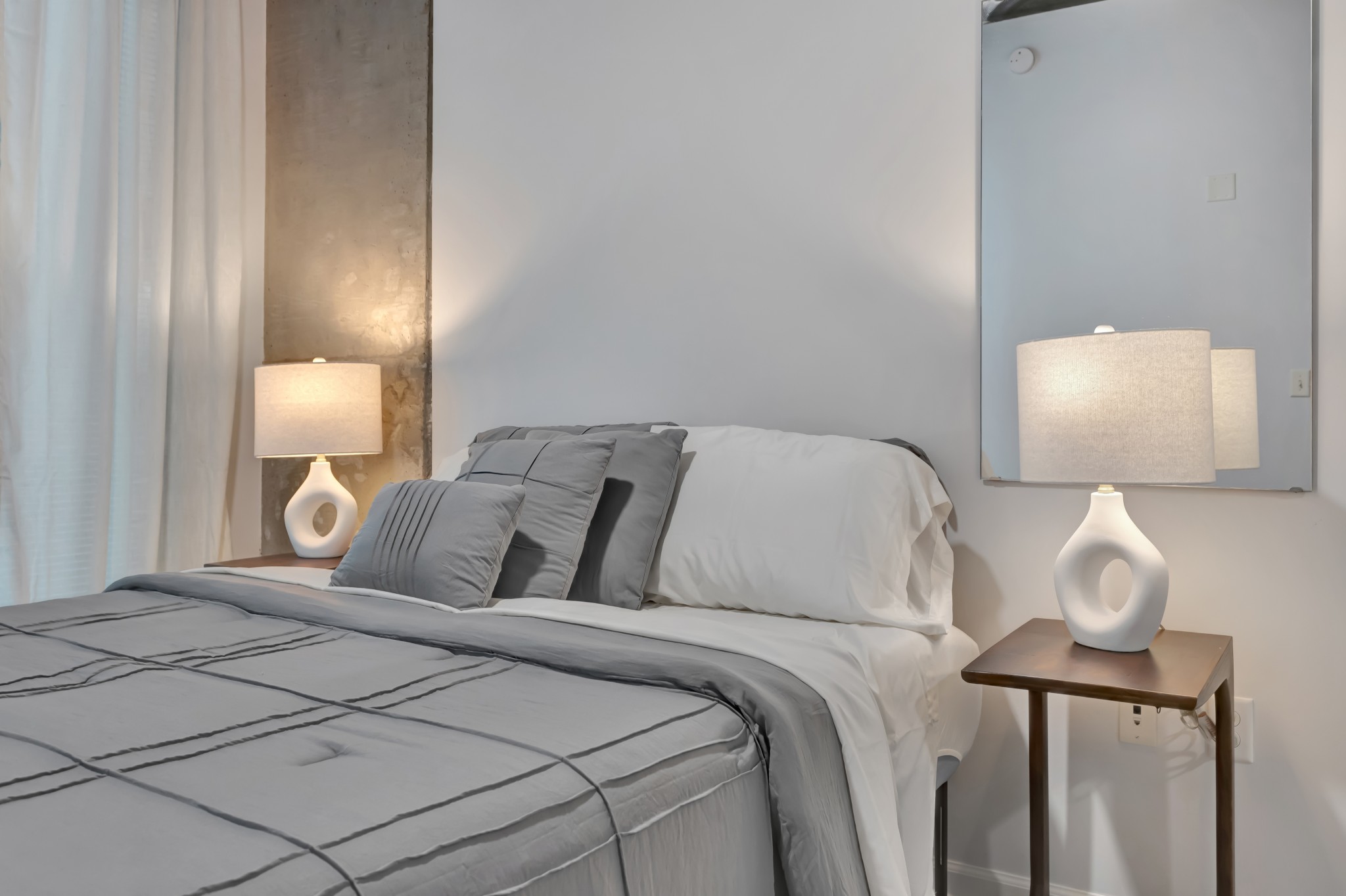 415 Church Street, Unit 1805 Nashville, TN 37219 - Photo 32 of 66 a bed room with a bed and a lamp