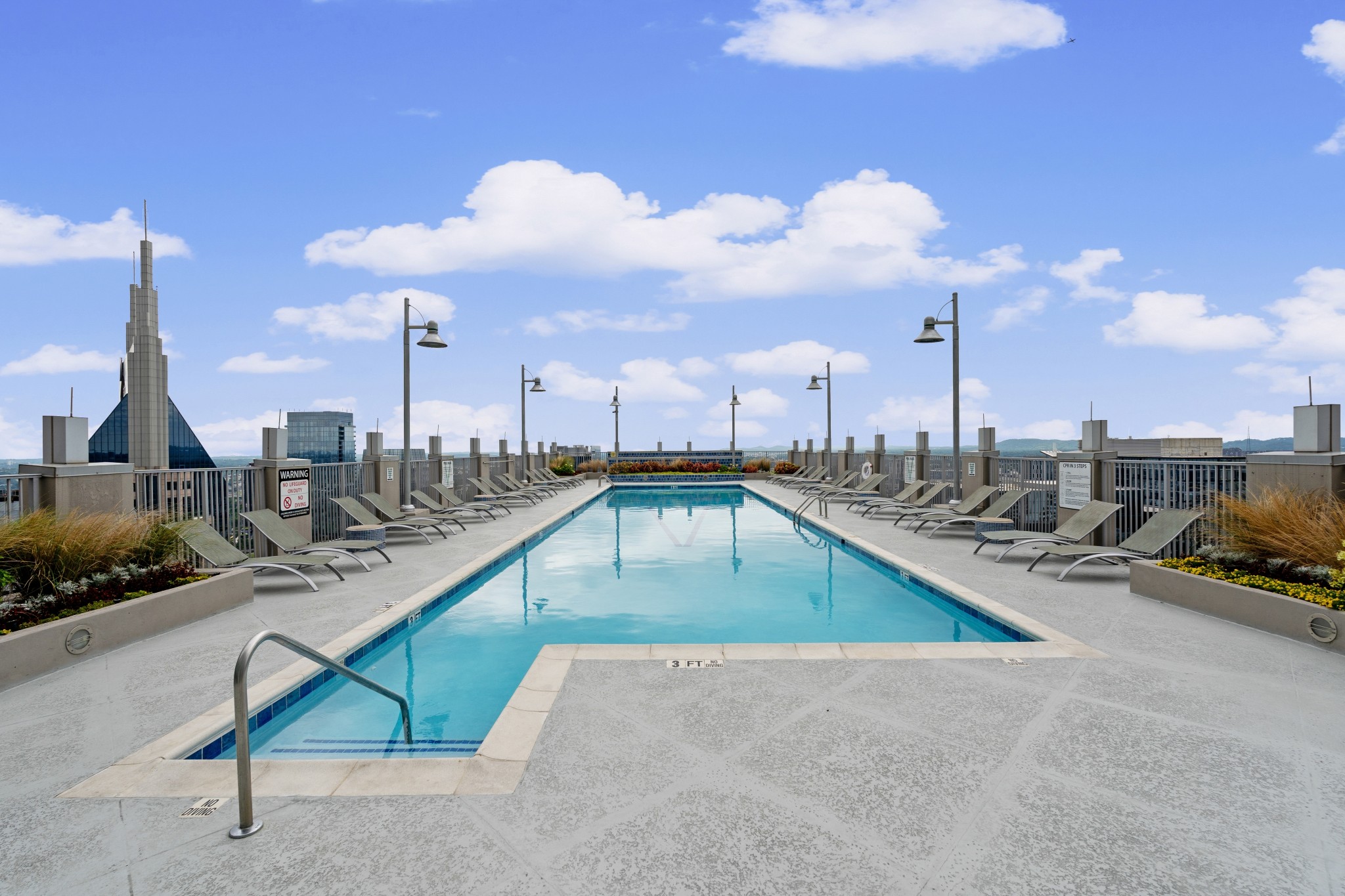 415 Church Street, Unit 1805 Nashville, TN 37219 - Photo 40 of 66 a view of a swimming pool and lounge chairs