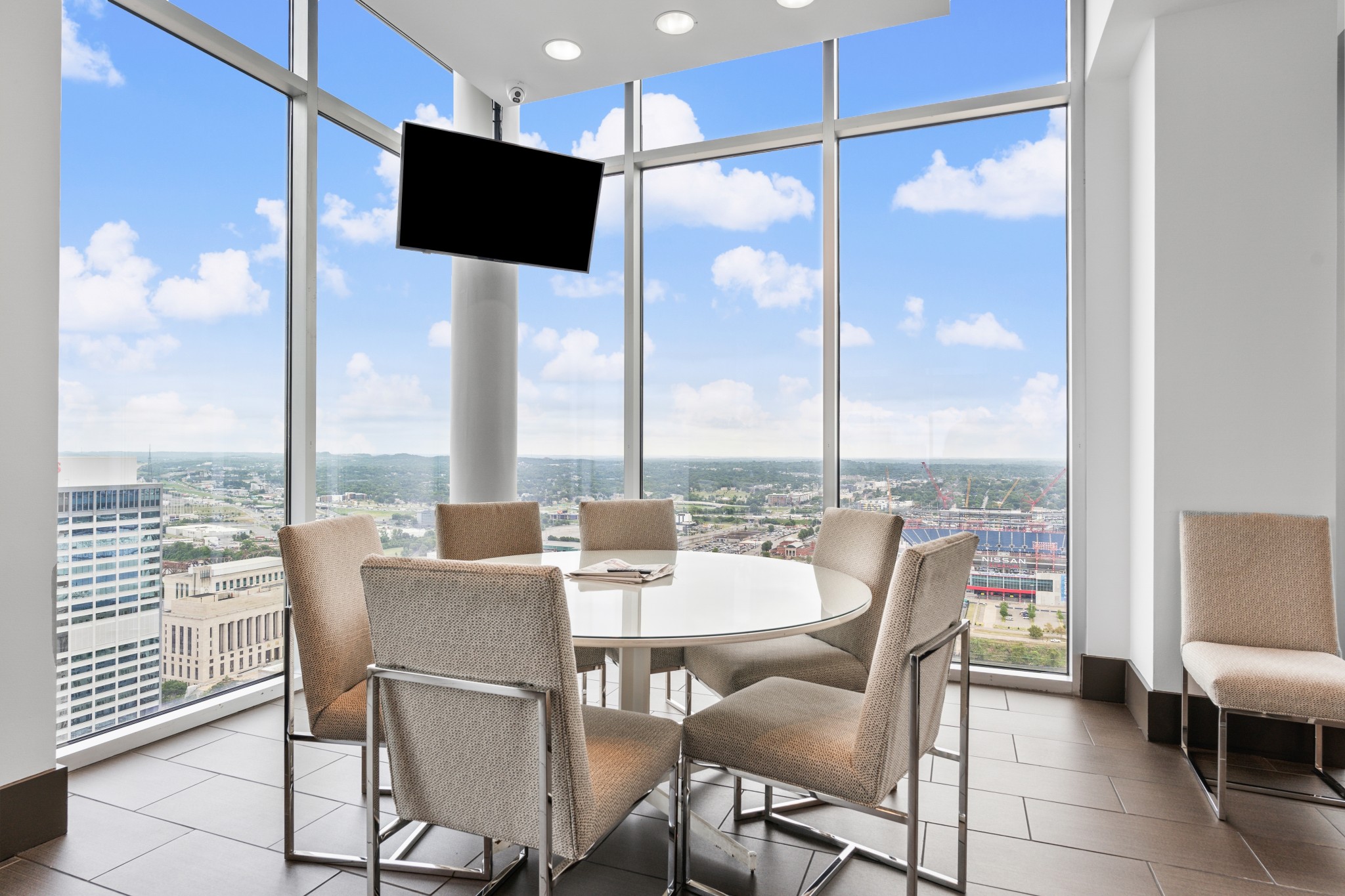 415 Church Street, Unit 1805 Nashville, TN 37219 - Photo 49 of 66 a dining room with furniture a floor to ceiling window and kitchen view