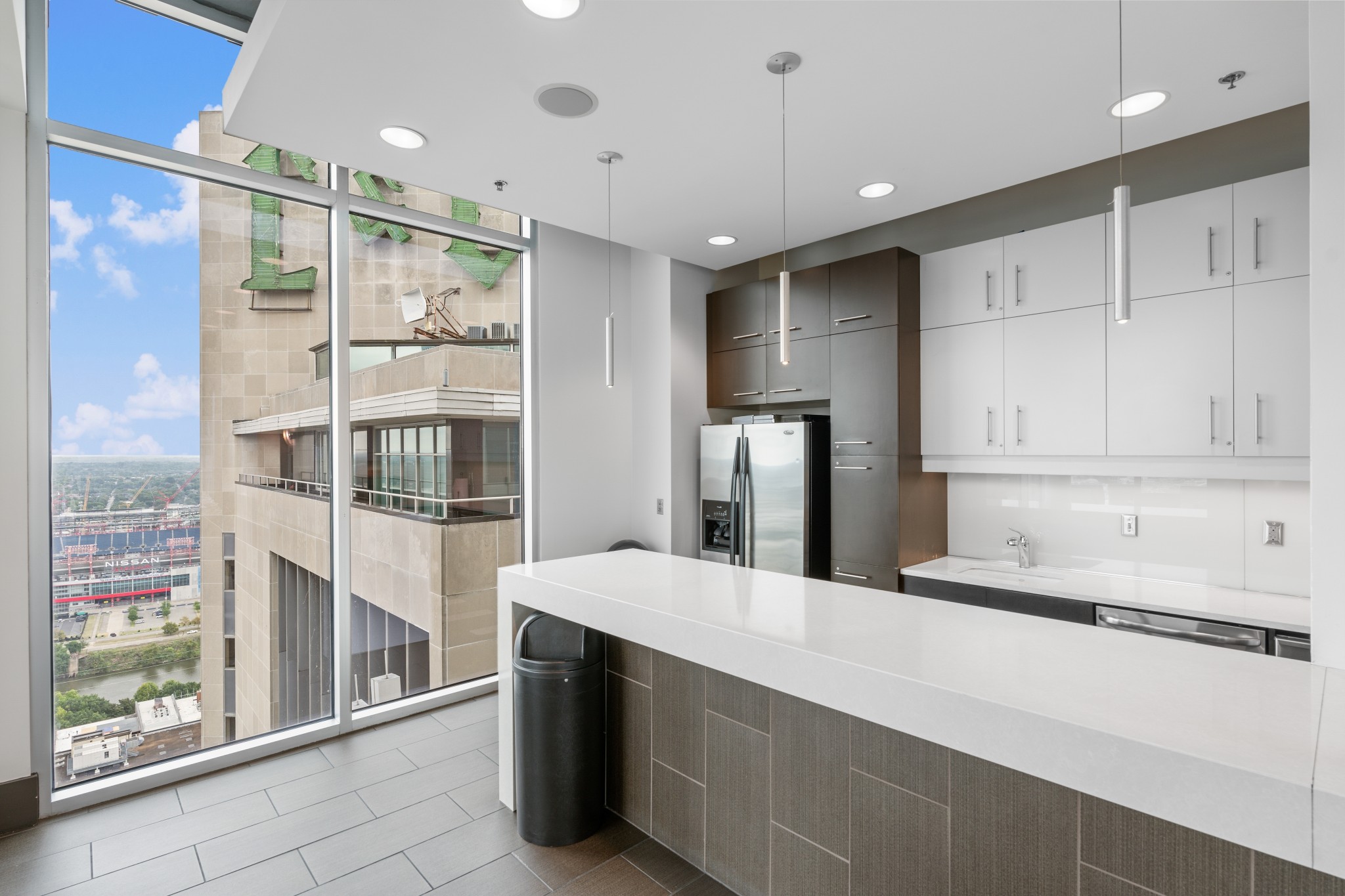 415 Church Street, Unit 1805 Nashville, TN 37219 - Photo 50 of 66 a large kitchen with kitchen island a large counter top space and stainless steel appliances