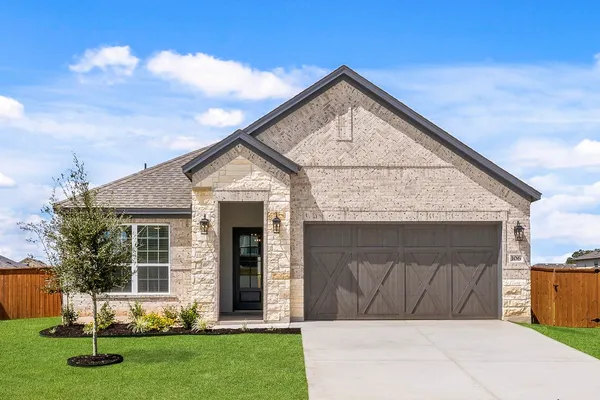 a front view of house with a yard and garage
