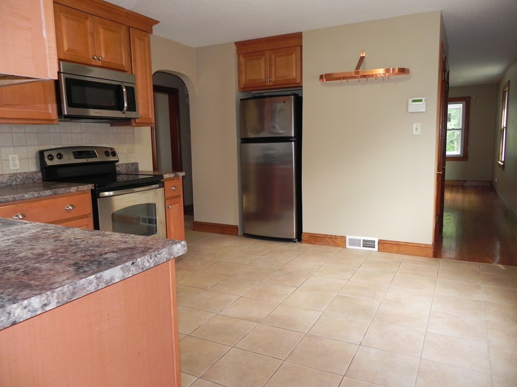 206 Parker Street Springfield, MA 01151 - Photo 3 of 21 a kitchen with stainless steel appliances granite countertop a refrigerator and a stove top oven