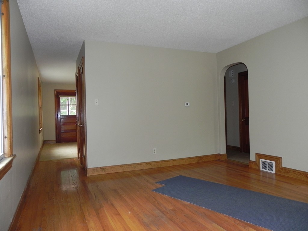 206 Parker Street Springfield, MA 01151 - Photo 4 of 21 a view of a room with wooden floor and closet