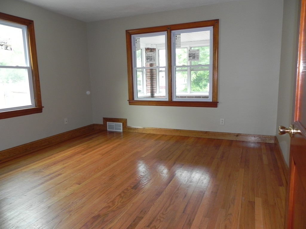 206 Parker Street Springfield, MA 01151 - Photo 9 of 21 a view of an empty room with wooden floor and a window