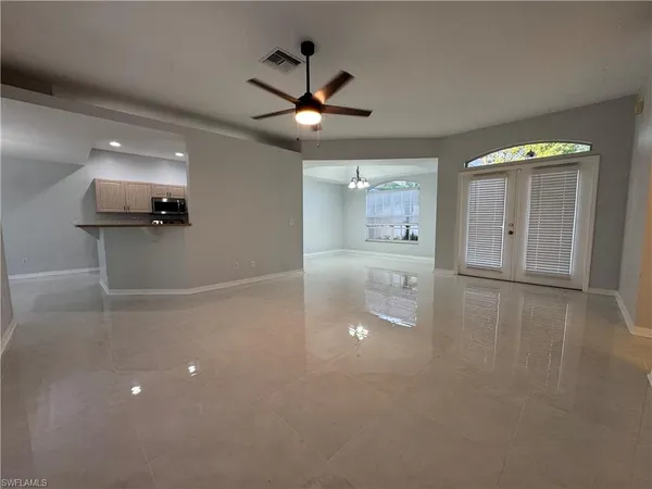 a view of a livingroom with a ceiling fan and window