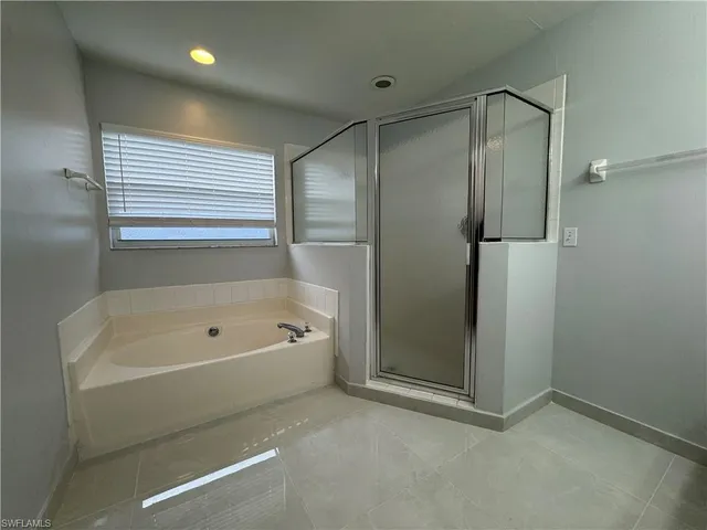a bathroom with a bathtub and a shower