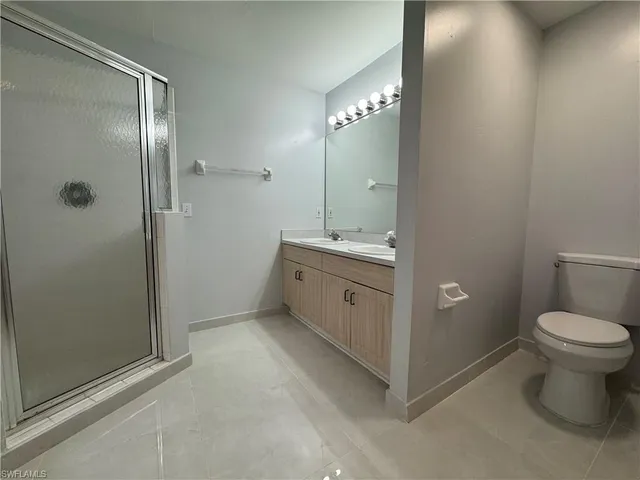 a bathroom with a toilet sink and shower