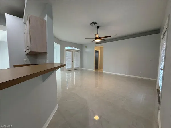 a view of a kitchen with a sink and a refrigerator