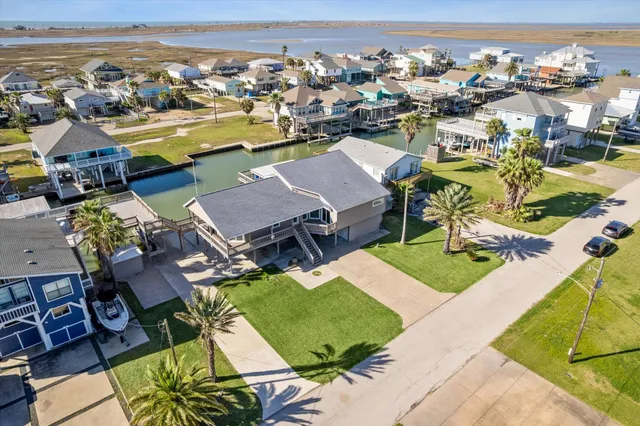 an aerial view of a house with a swimming pool patio and outdoor seating