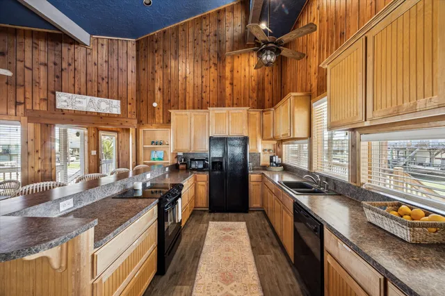 a kitchen with stainless steel appliances a dining table chairs stove and a refrigerator