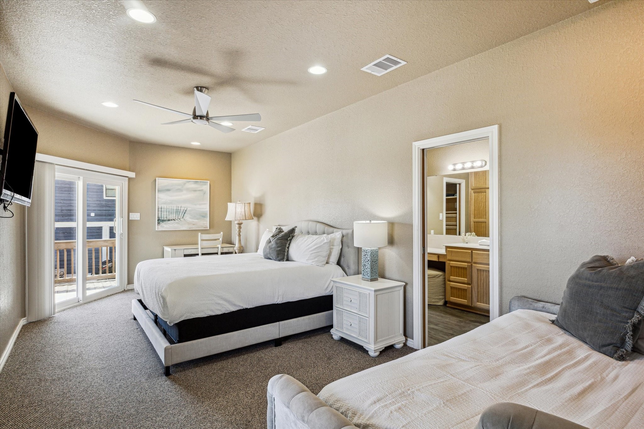 235 Galleon Freeport, TX 77541 - Photo 20 of 45 a bedroom with a large bed and a chandelier