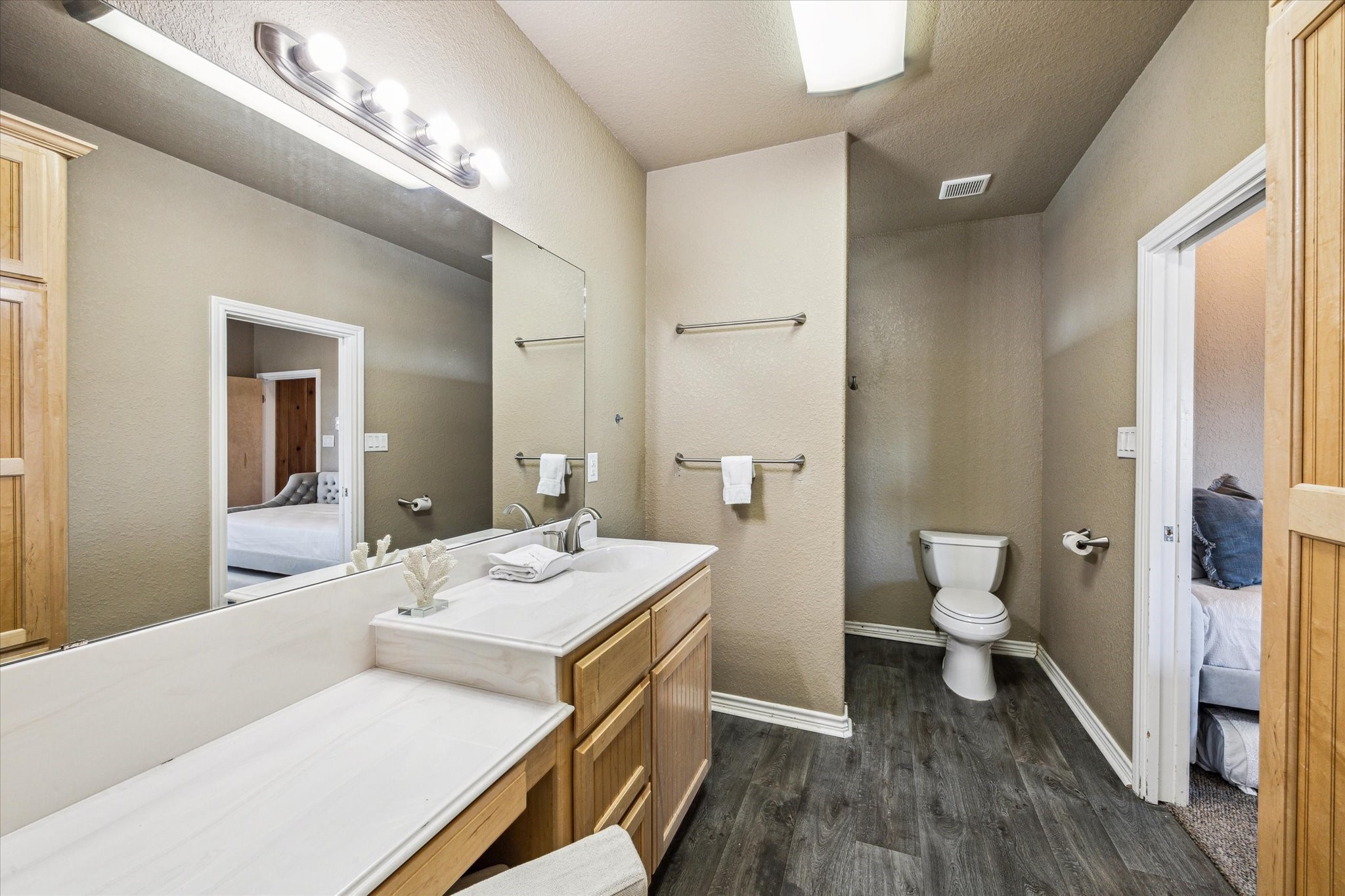 235 Galleon Freeport, TX 77541 - Photo 22 of 45 a bathroom with a sink a toilet and a large mirror