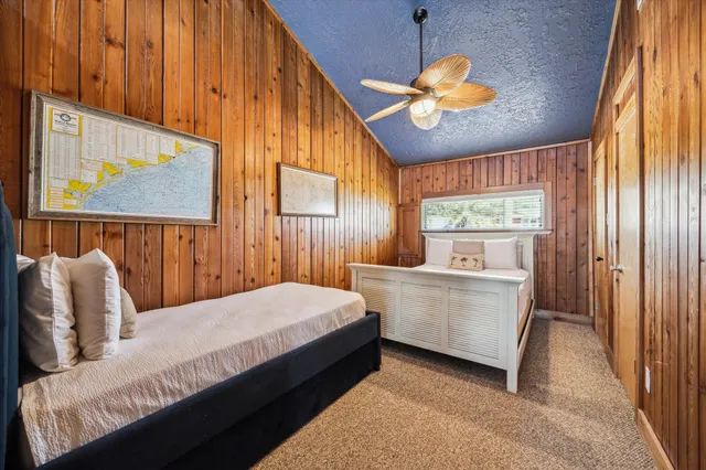 a bedroom with a large bed and a chandelier