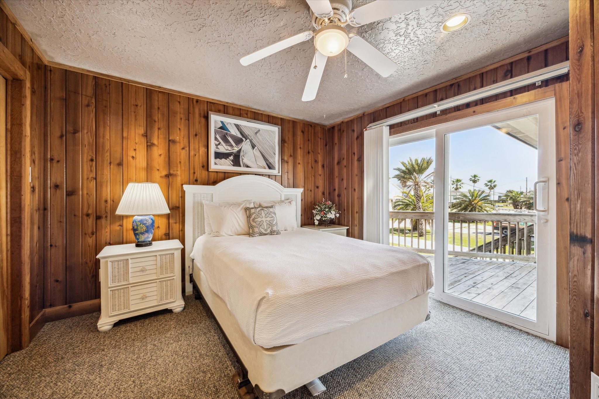 235 Galleon Freeport, TX 77541 - Photo 28 of 45 a bedroom with a large bed and a chandelier