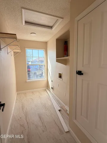 a view of an empty room with a window