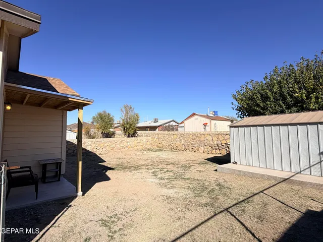 a view of a house with wooden fence