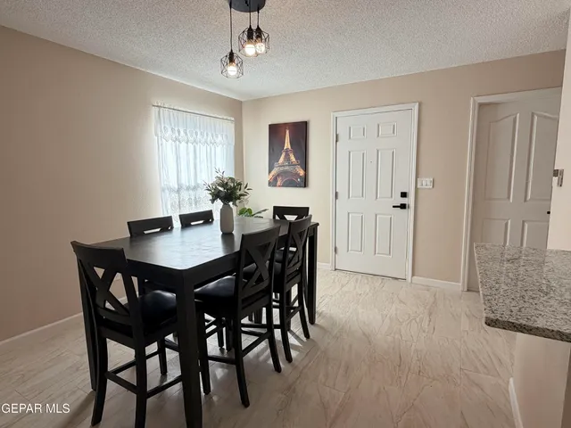a view of a dining room with furniture and chandelier