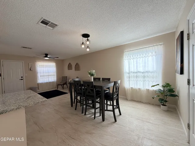 a view of a dining room with furniture and window
