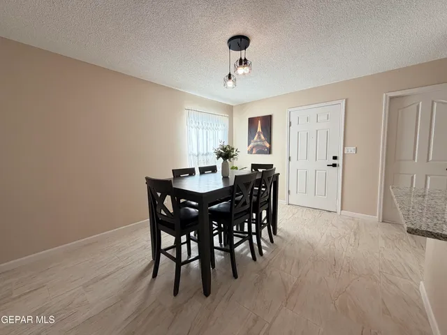 a view of a a dining room with furniture window and wooden floor
